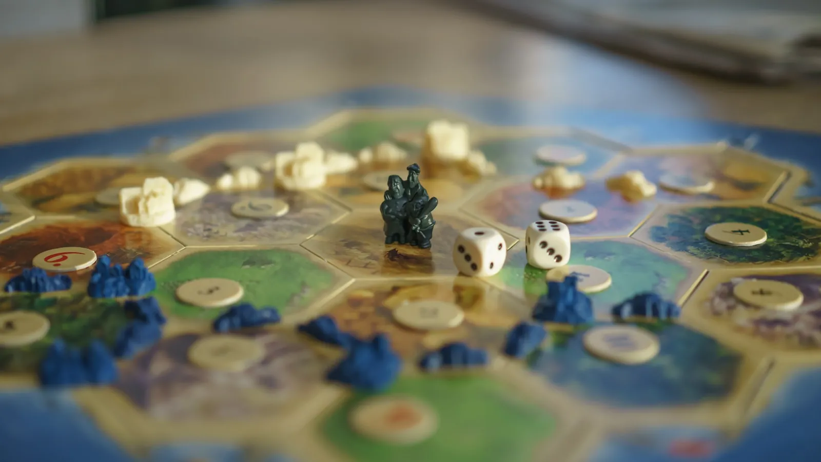 Board game tiles and dice in play on a tabletop